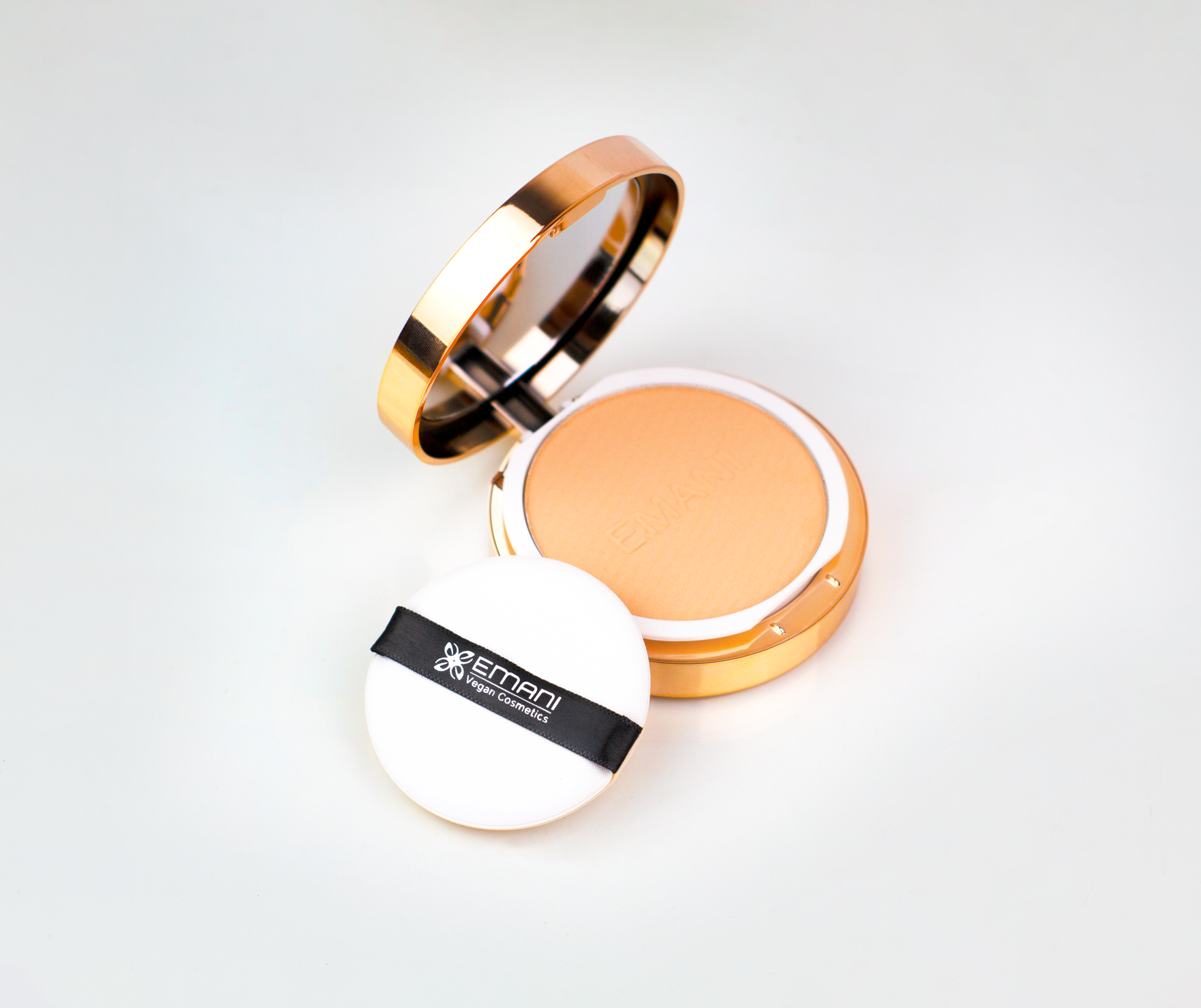 High-quality vegan compact powder with puff and mirror in elegant packaging.